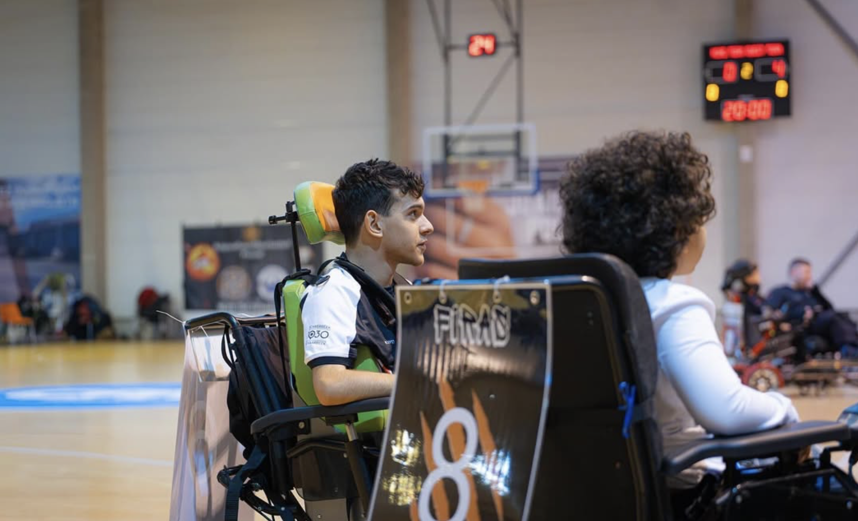 [Caption: A stack of soccer balls with alternating red stars and hexagon sections atop a conference table.]